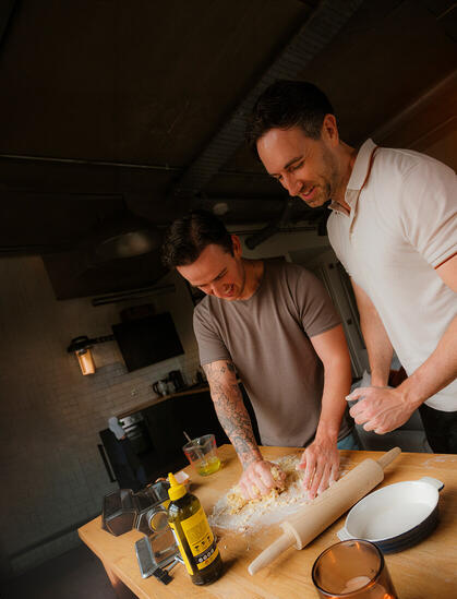 a couple cooking in the kitchen